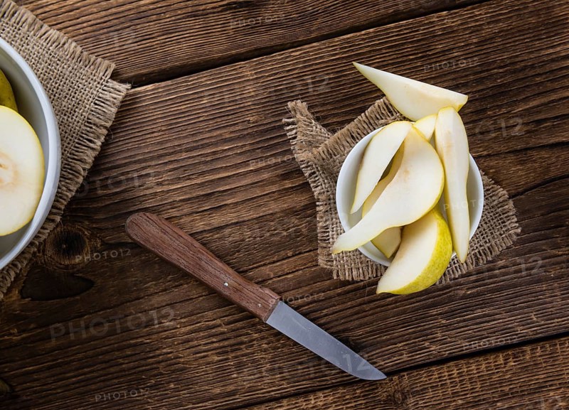 Pears (selective focus) on an old wooden table (close-up shot)