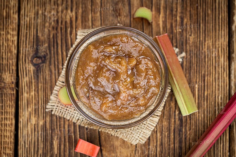 Rhubarb Jam on an old wooden table as detailed close up shot (selective focus)