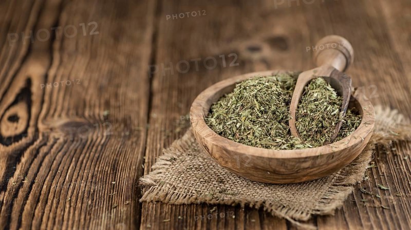 Portion of Stevia Leaves (dried, close-up shot) on wooden background