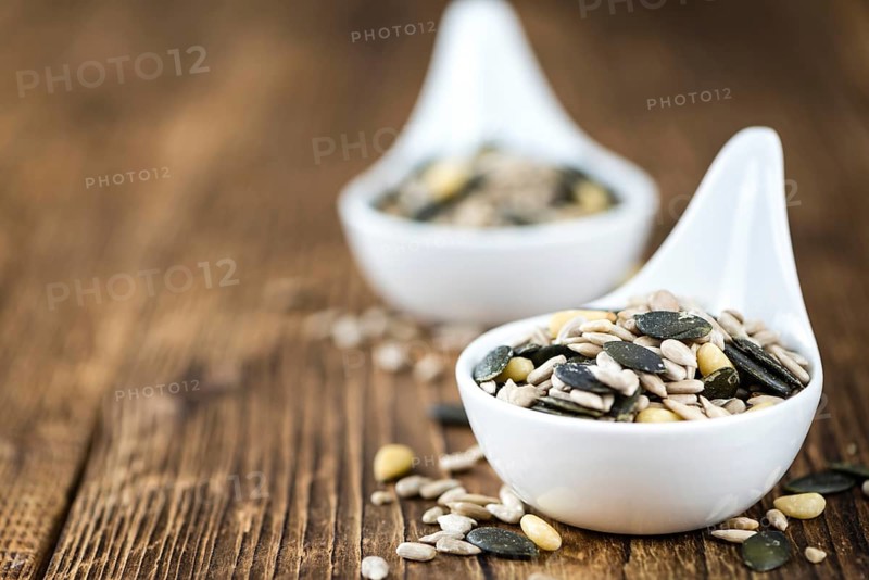 Mixed Seeds (close-up shot, selective focus) on vintage wooden background