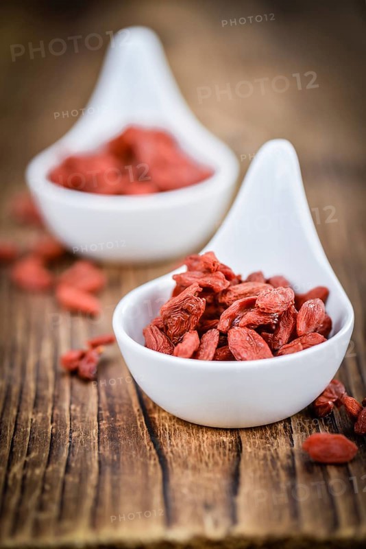 Fresh made Dried Goji Berries on a vintage background (close-up shot)