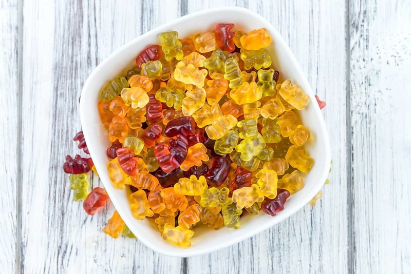Bowl with Gummy Candy (selective focus) on wooden background