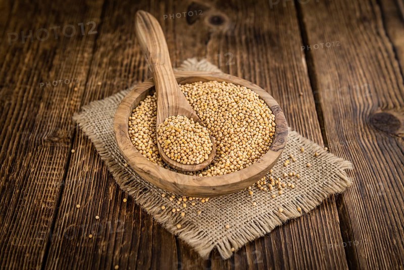 Mustard Seeds on a vintage background as detailed close-up shot (selective focus)