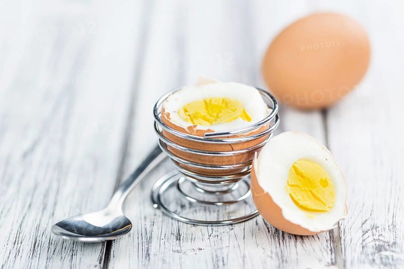 Some boiled Eggs (close-up shot, selective focus) on an old wooden table