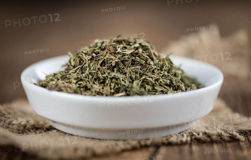 Heap of dried Stevia leaves (sweetener) on vintage background (close-up shot)