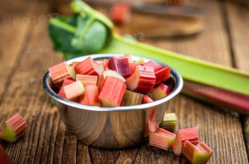 Chopped Rhubarb on an old wooden table (close up shot, selective focus)