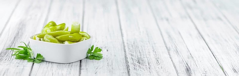 Fresh made Green Chilis (filled with cheese) on a vintage background (close-up shot)