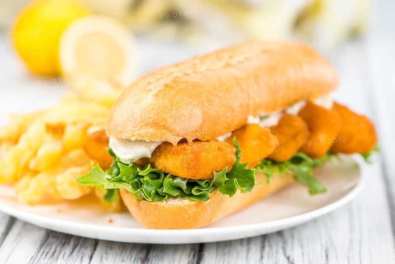 Fresh made Snack (Sandwich with Fish Sticks) on an old wooden table