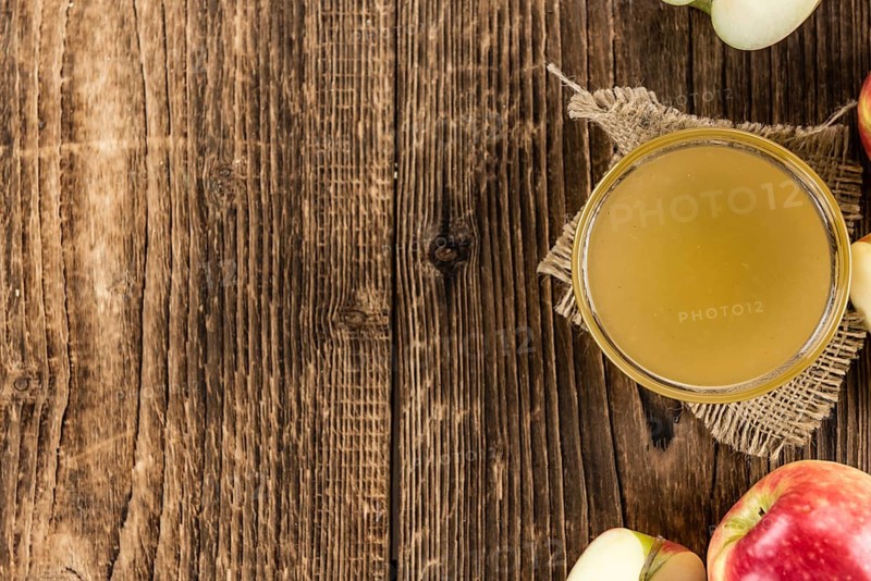 Wooden table with Applesauce (close-up shot, selective focus)