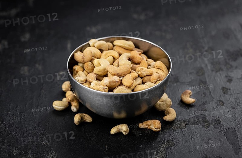 Some roasted Cashew Nuts as detailed close up shot (selective focus)