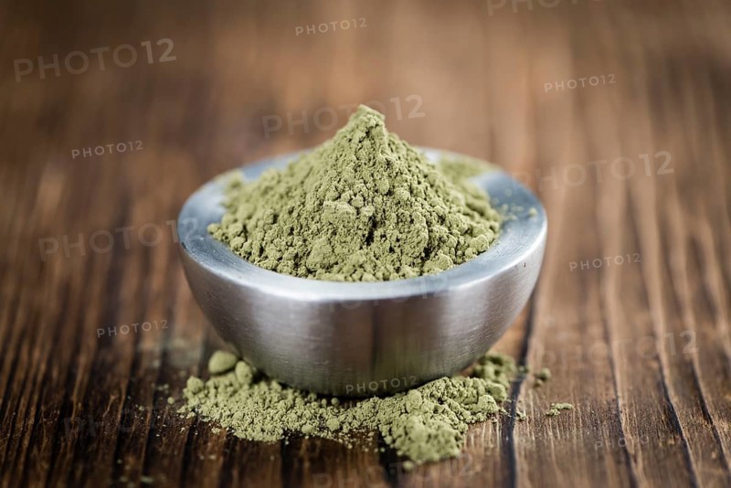 Stevia leaf powder (detailed close-up shot) on rustic wooden background