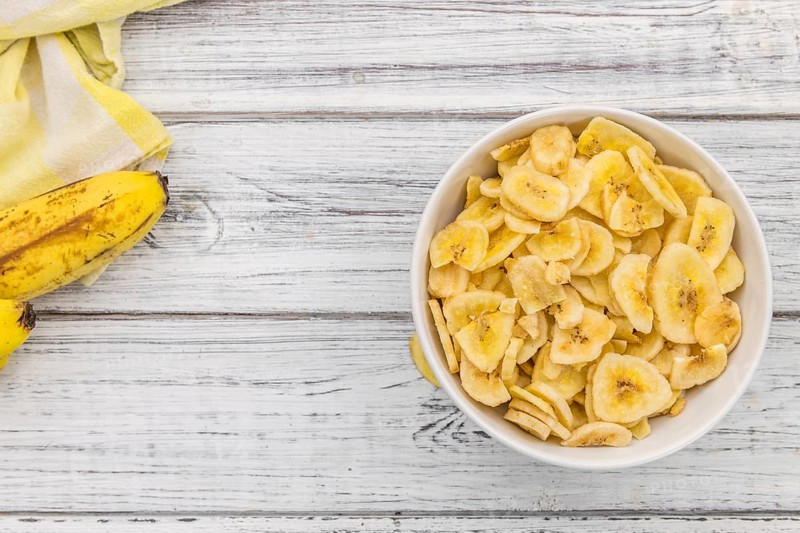 Portion of fresh Dried Banana Chips close-up shot, selective focus