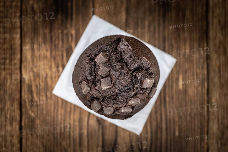 Vintage wooden table with Chocolate Muffins (selective focus, close-up shot)