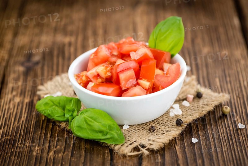Diced Tomatoes on a vintage background as detailed close-up shot (selective focus)