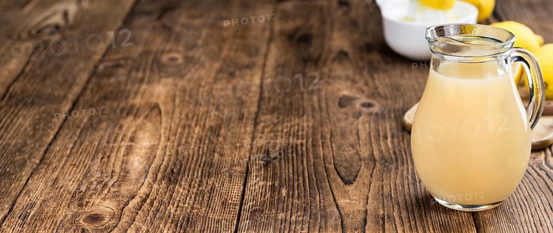 Fresh made Juice (lemon) on a vintage background (close-up shot)