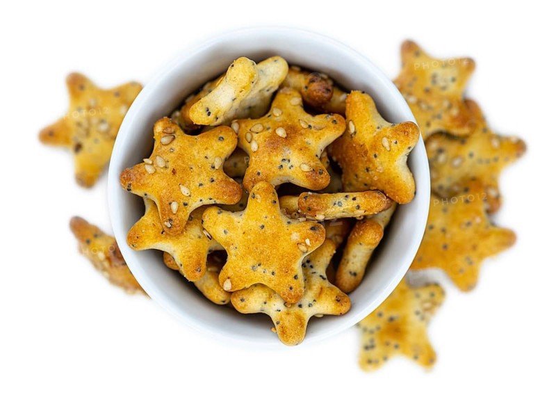 Portion of mixed Snacks isolated on white background (detailed close up shot, selective focus)
