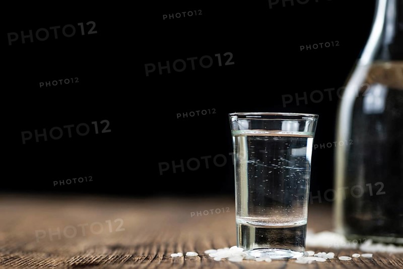 Japanese Sake drink on an old wooden table (close-up shot)