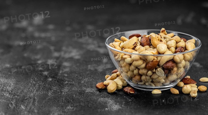 Roasted and salted nuts as detailed close up shot (selective focus)