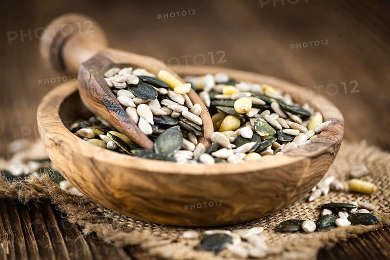 Mixed Seeds (close-up shot, selective focus) on vintage wooden background