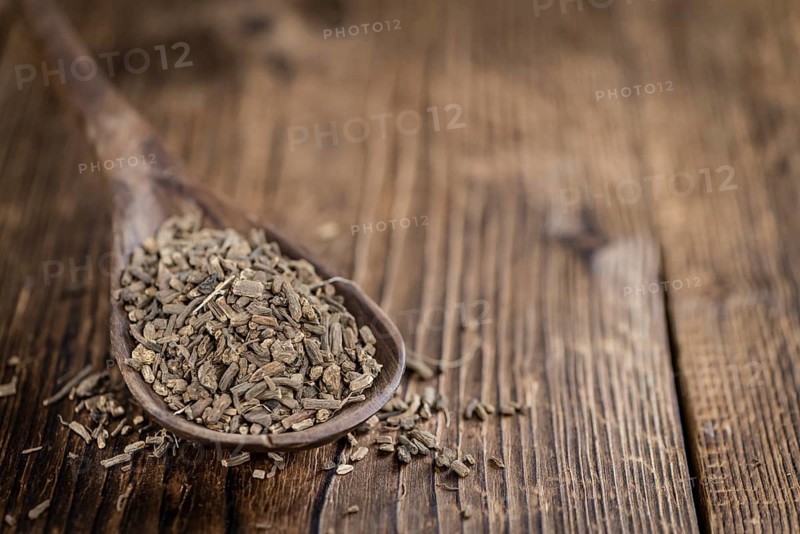 Dried Valerian roots (detailed close-up shot) on wooden background