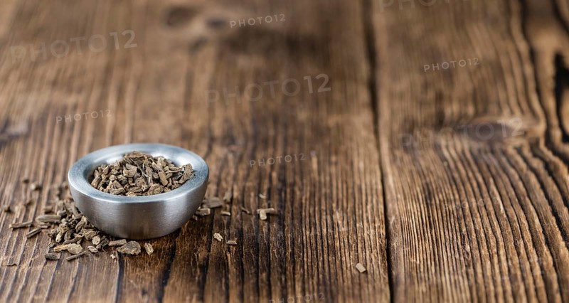 Valerian roots (dried, detailed close-up shot) on wooden background