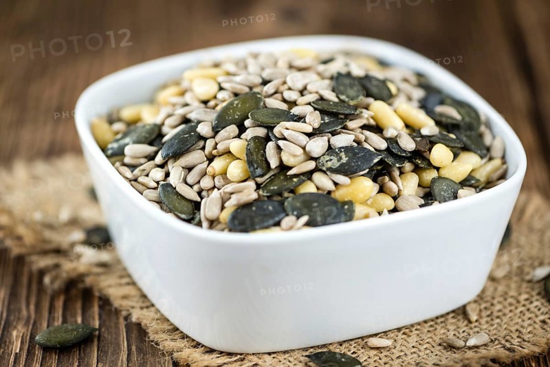 Heap of mixed Seeds (close-up shot) on wooden background