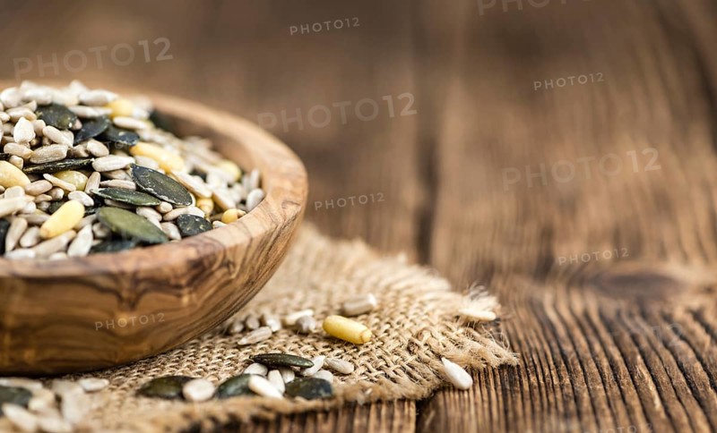 Mixed Seeds (close-up shot, selective focus) on vintage wooden background