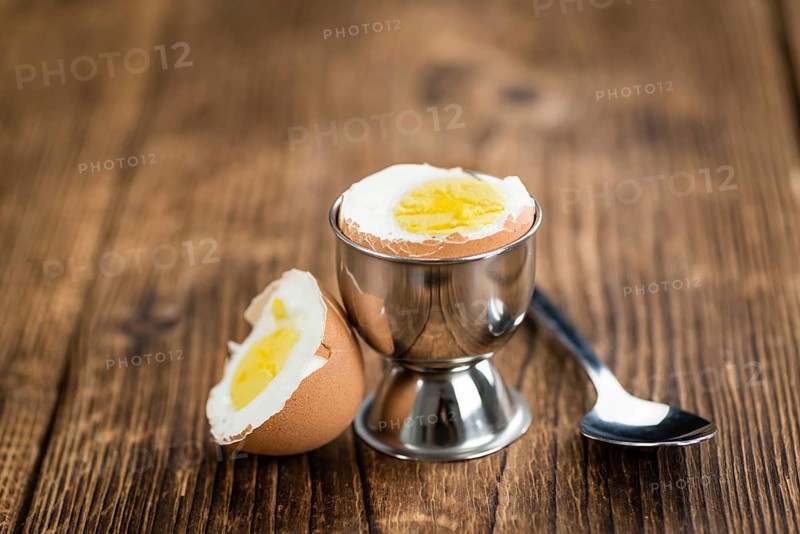 Some boiled Eggs (close-up shot, selective focus) on an old wooden table