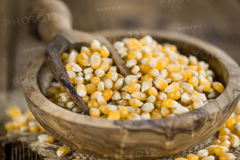 Wooden table with a portion of Corn (selective focus, close-up shot)