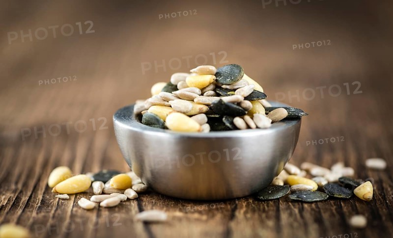 Mixed Seeds (close-up shot, selective focus) on vintage wooden background