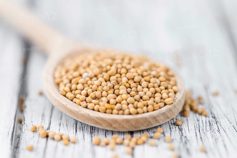 Seeds (Mustard) as high detailed close-up shot on a vintage wooden table (selective focus)