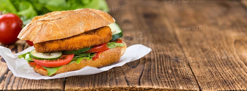 Fresh made Chicken Schnitzel on a bun (close-up shot, selective focus)