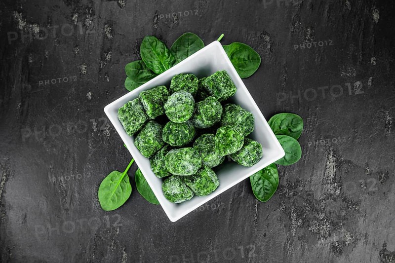 Frozen spinach cubes as detailed close up shot (selective focus)