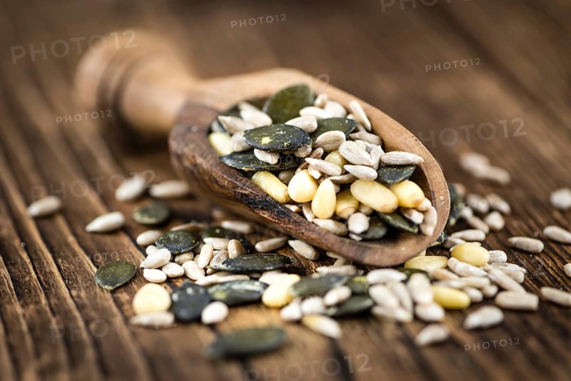 Heap of mixed Seeds (close-up shot) on wooden background