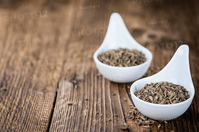Valerian roots (dried, detailed close-up shot) on wooden background