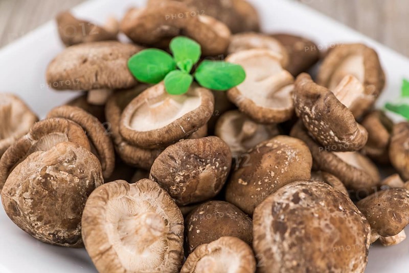 Portion of fresh Shiitake mushrooms close-up shot, selective focus