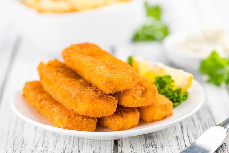 Fisch Sticks (close-up shot) on an old wooden table (selective focus)