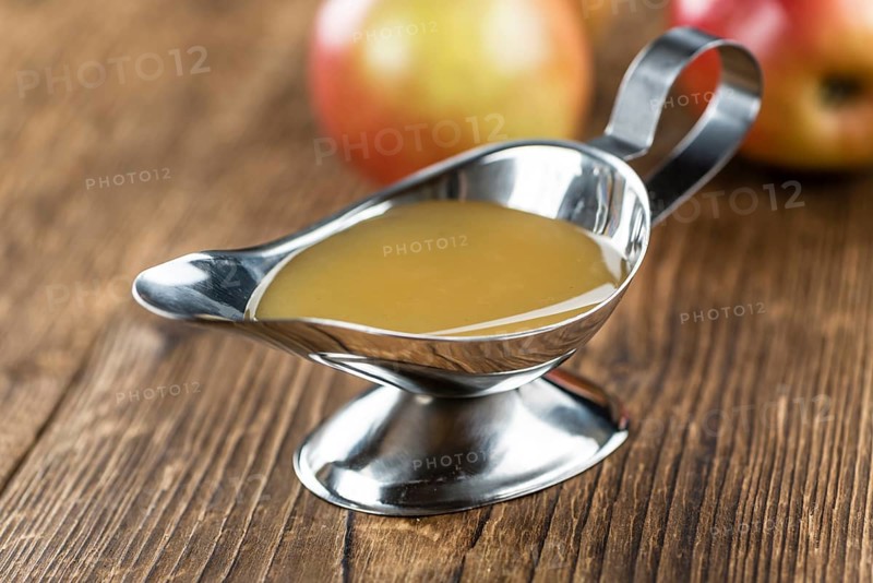 Wooden table with Applesauce (close-up shot, selective focus)