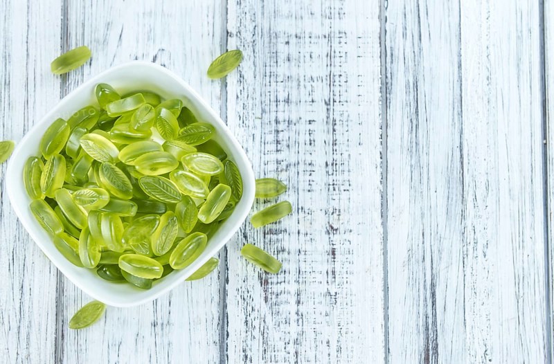 Gummy Candy with lime taste (selective focus) on wooden background