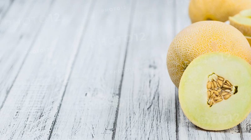 Fresh made Honeydew Melon on a vintage background (close-up shot)