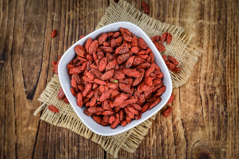 Goji Berries on a vintage background as detailed close-up shot (selective focus)