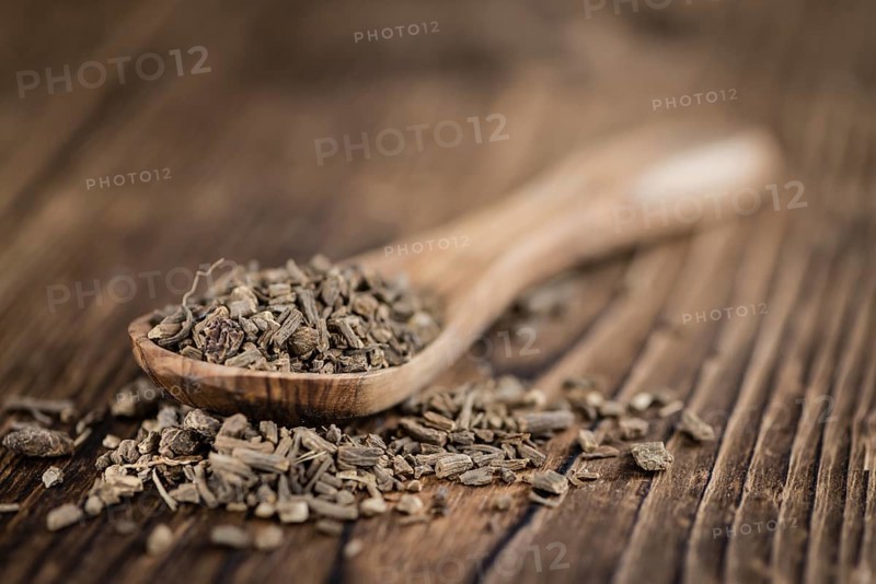 Dried Valerian roots (detailed close-up shot) on wooden background