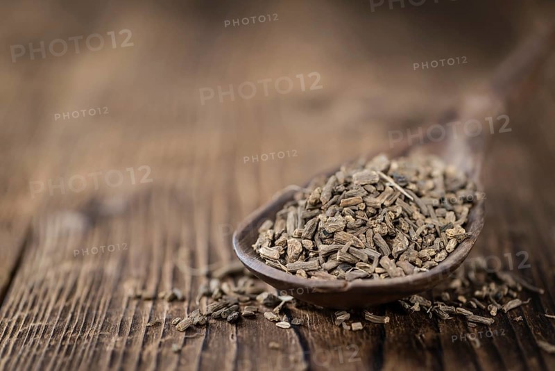 Heap of valerian roots (close-up shot) on vintage wooden background