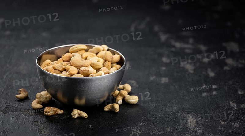Some roasted Cashew Nuts as detailed close up shot (selective focus)