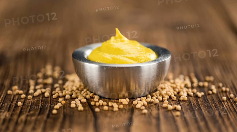 Mustard on a vintage background as detailed close-up shot (selective focus)