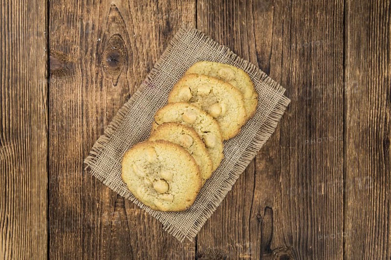 Vintage wooden table with Cookies (selective focus, close-up shot)