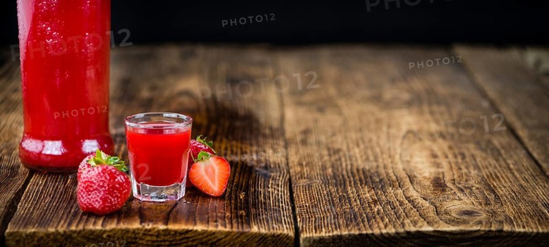 Some homemade Strawberry liqueur as detailed close-up shot, selective focus