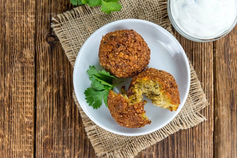Wooden table with Falafels (close-up shot, selective focus)