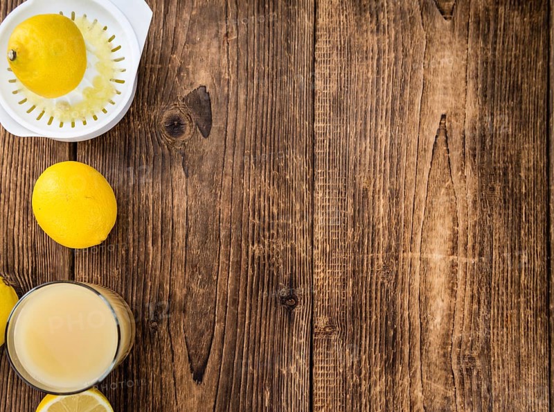 Homemade Lemon Juice on an wooden table (selective focus) as detailed close-up shot