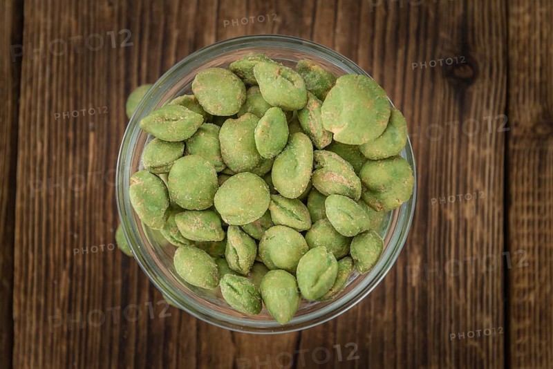 Wasabi Peanuts on a vintage background as detailed close-up shot (selective focus)
